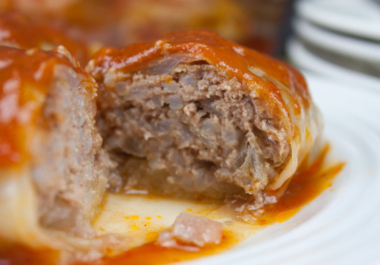 Easy Stuffed Cabbage Rolls - Tender leaves of cabbage stuffed with flavorful seasoned beef and rice, baked in a mouthwatering tomato sauce.