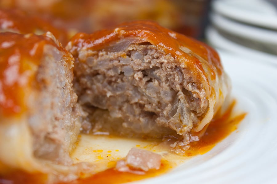 Easy Stuffed Cabbage Rolls - Tender leaves of cabbage stuffed with flavorful seasoned beef and rice, baked in a mouthwatering tomato sauce.