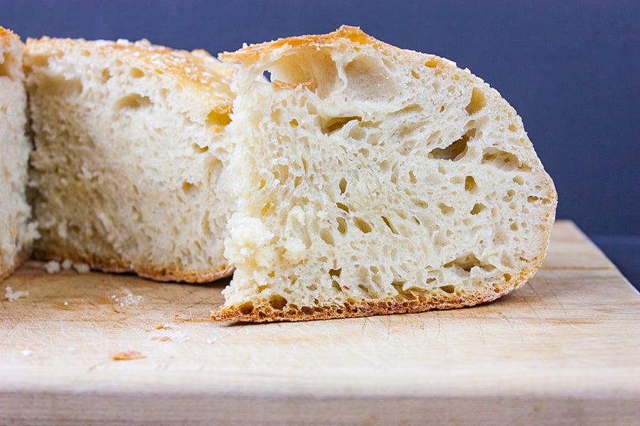 No Knead Large Dutch Oven Bread on a wooden cutting board.