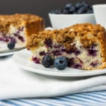 Blueberry Streusel Coffee Cake on a white platter with a coffee cup.