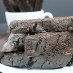 Dark Chocolate Biscotti stacked on a white plate.