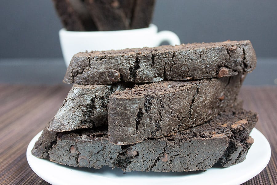 Dark Chocolate Biscotti stacked on a white plate.