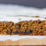 Cut raisin bars on a wooden cutting board.
