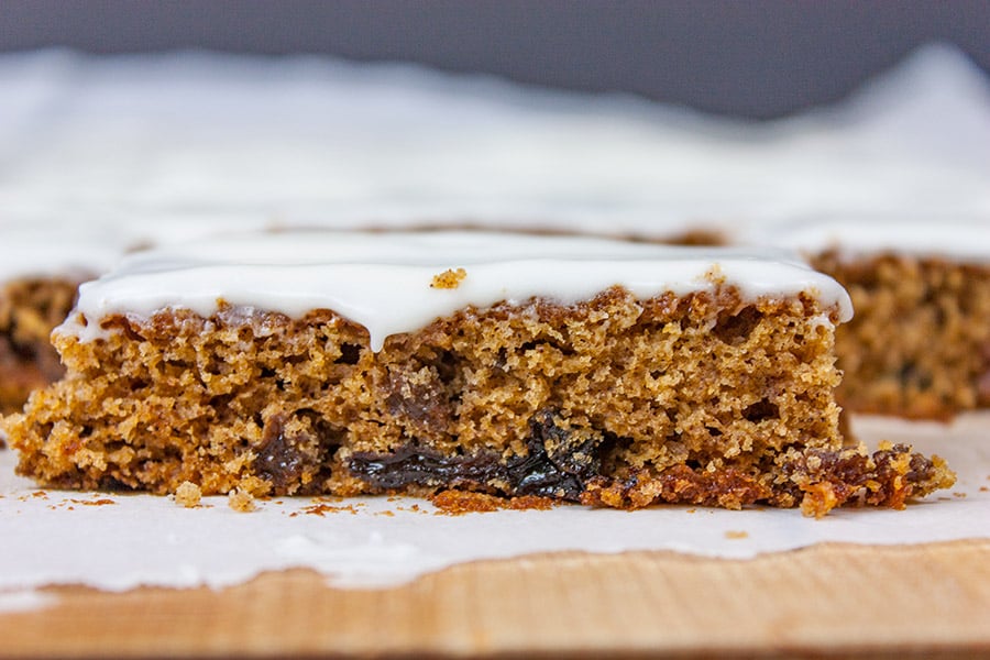 Cut raisin bars on a wooden cutting board.