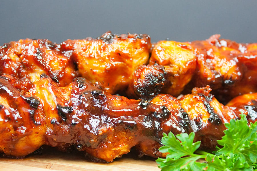 Bacon Paste BBQ Chicken Kebabs on a cutting board.