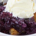 Easy Blackberry Cobbler with ice cream on top.