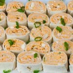 Easy Buffalo Chicken Pinwheels - A perfect party, barbecue, game day or large gathering appetizer. Cool, creamy, tangy and loaded with buffalo wing flavor.