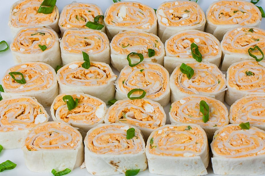 Easy Buffalo Chicken Pinwheels - A perfect party, barbecue, game day or large gathering appetizer. Cool, creamy, tangy and loaded with buffalo wing flavor.