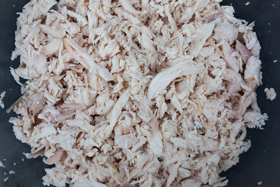 Savory Chicken Salad - shredded chicken in a glass mixing bowl