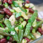 Homemade Five Bean Salad in a glass serving bowl.