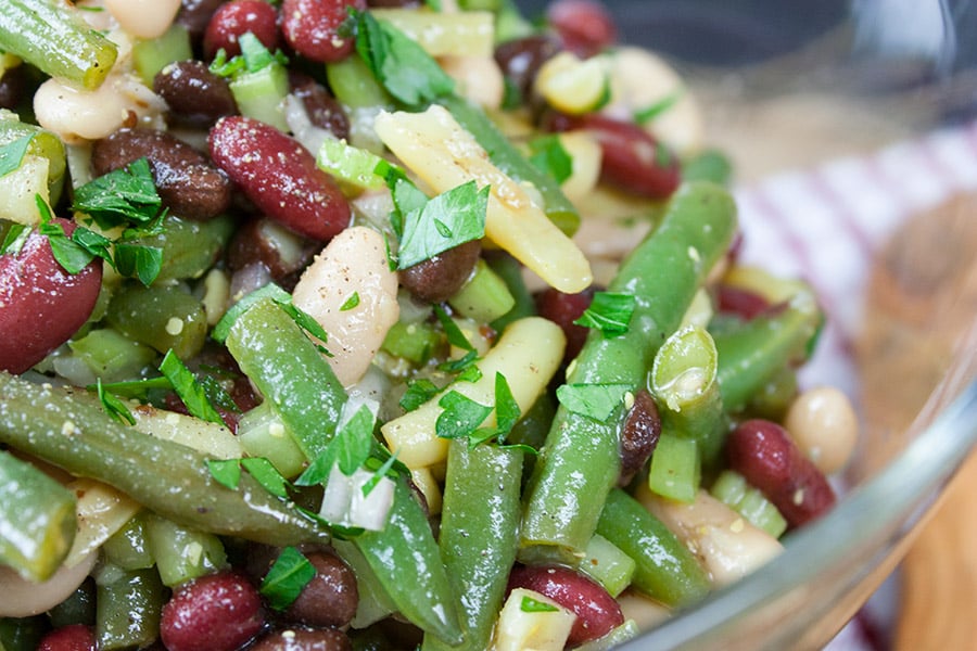 Homemade Five Bean Salad in a glass serving bowl.