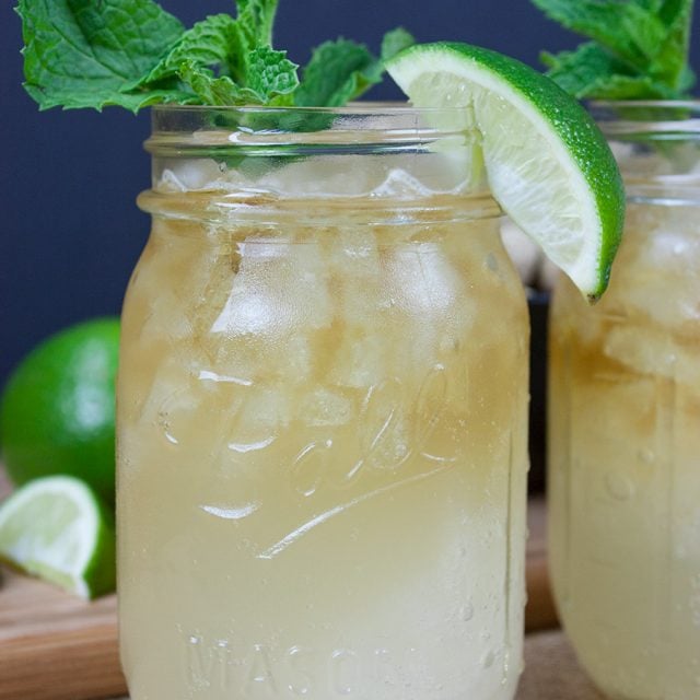 Kentucky Mule served in a large mason jar garnished with fresh mint and a lime wedge.