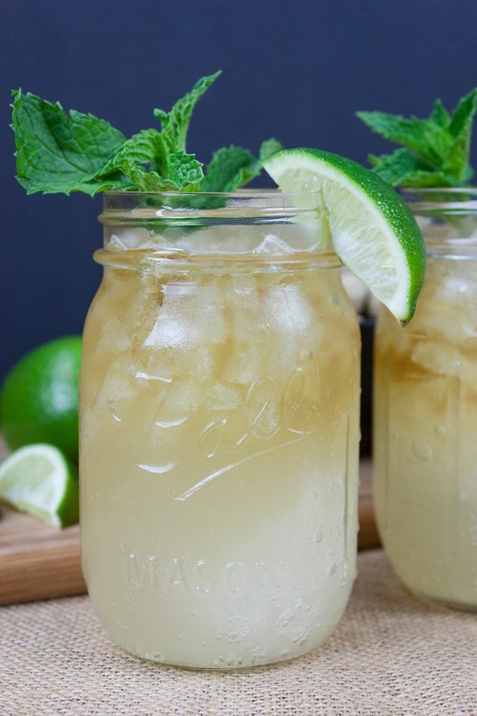 Kentucky Mule served in a large mason jar garnished with fresh mint and a lime wedge.