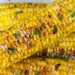 Grilled Parmesan Corn On The Cob stacked on top of each other.