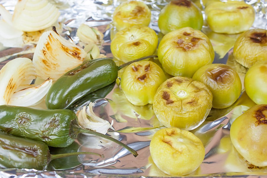 Homemade Roasted Tomatillo Salsa (salsa verde) - roasted tomatillos, jalapenos, and onions on a foiled lined baking sheet