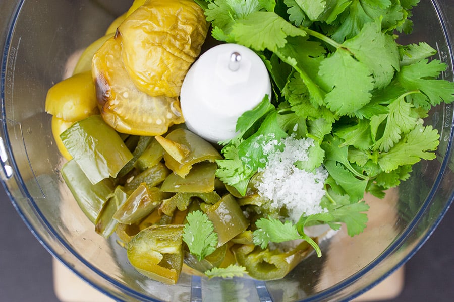 Homemade Roasted Tomatillo Salsa (salsa verde) - roasted tomatillos, jalapenos, and onions in the bowl of a food processor