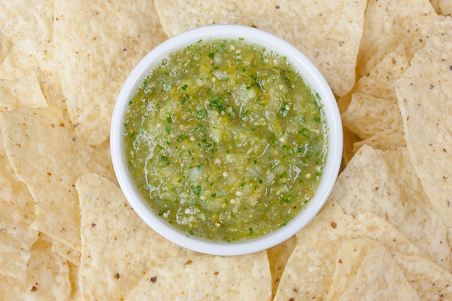 Homemade Roasted Tomatillo Salsa (salsa verde) - in a white ramekin surrounded by tortilla chips