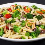 Lemon Veggie Pasta Salad served in a shallow white bowl.