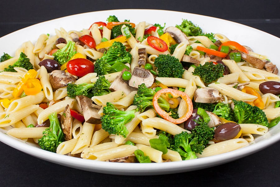 Lemon Veggie Pasta Salad served in a shallow white bowl.