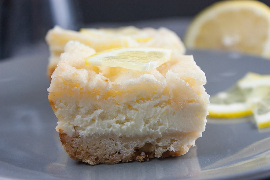 closeup of the Lemon Cheesecake Shortbread Bars on a gray plate