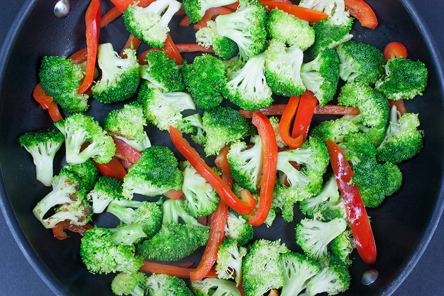 Easy Chicken and Broccoli Stir Fry - broccoli and red bell peppers in a skillet pan