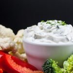 Fresh Herb Vegetable Dip with various vegetables around.