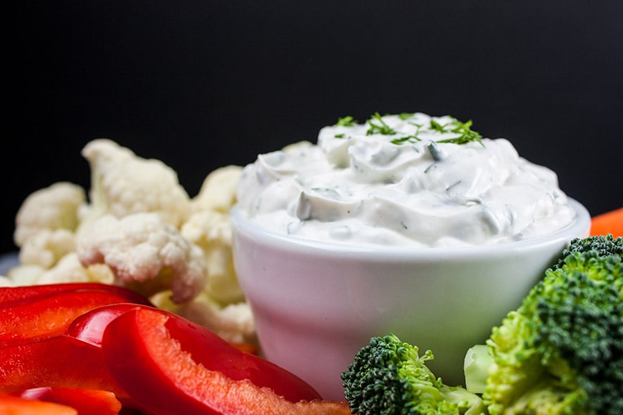 Fresh Herb Vegetable Dip with various vegetables around.