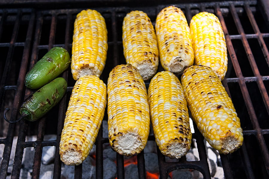 Grilled Mexican Street Corn Salad - corn cobs and jalapeños on the hot grill