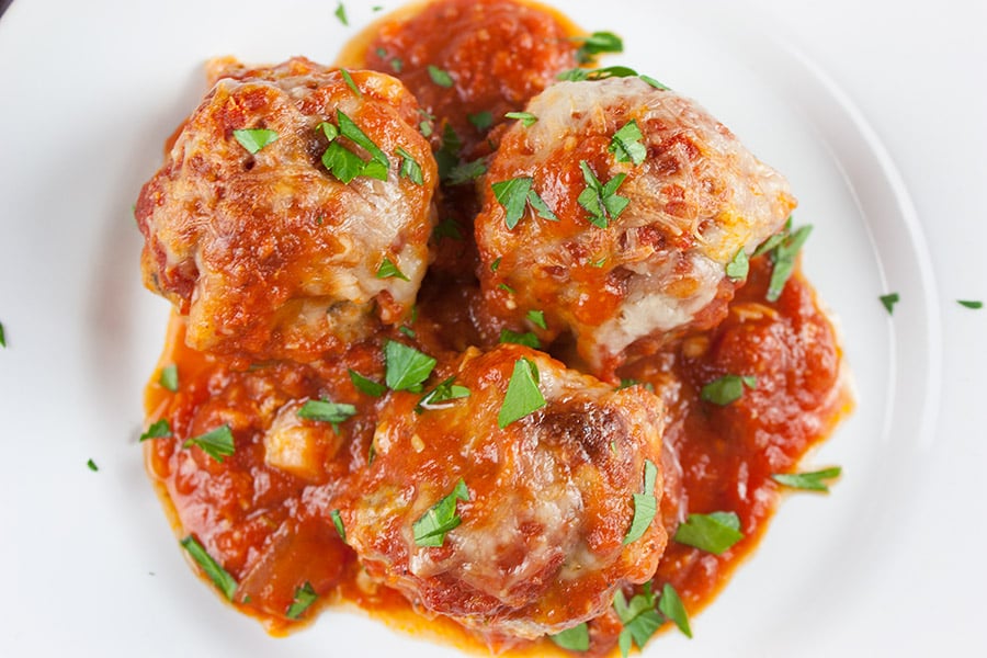 Easy Baked Parmesan Meatballs on a white platter.