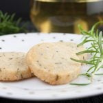 Savory Parmesan Rosemary Shortbread on a polka dotted plate with a rosemary garnish.
