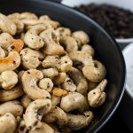 Salt and Pepper Roasted Cashews in a dark bowl.