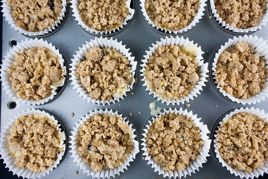 Lemon Streusel Blueberry Muffins batter in paper liners topped with streusel