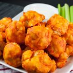 Baked Buffalo Cauliflower Bites in a white serving bowl.