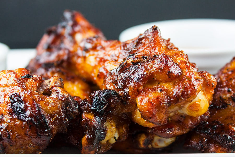 Cajun Smoked Wings - closeup of the wings on a white platter