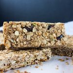 Homemade Granola Bars stacked up on a white plate.