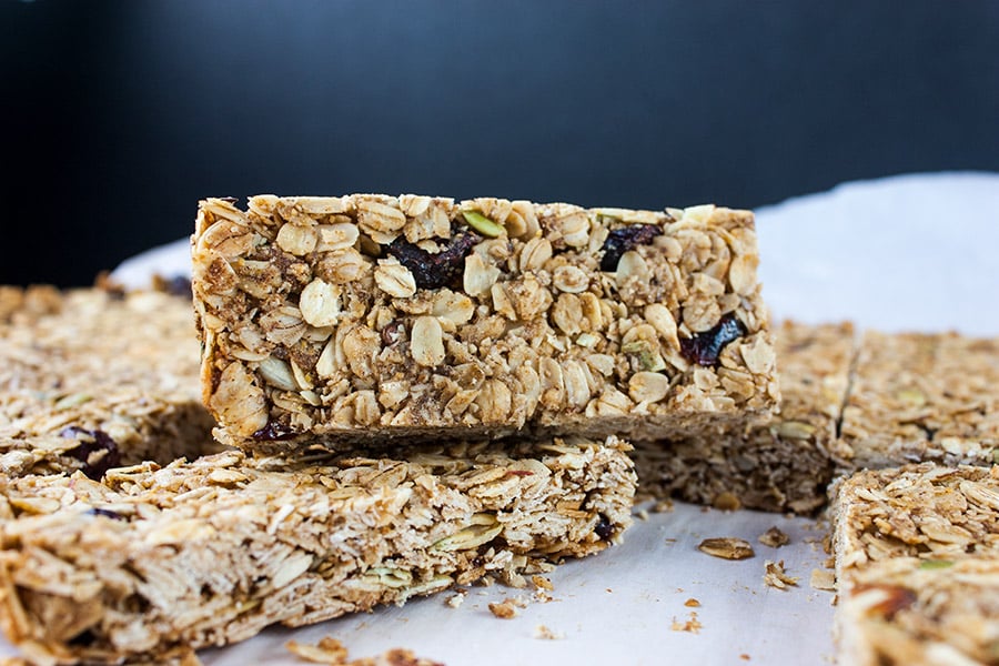 Homemade Granola Bars stacked up on a white plate.
