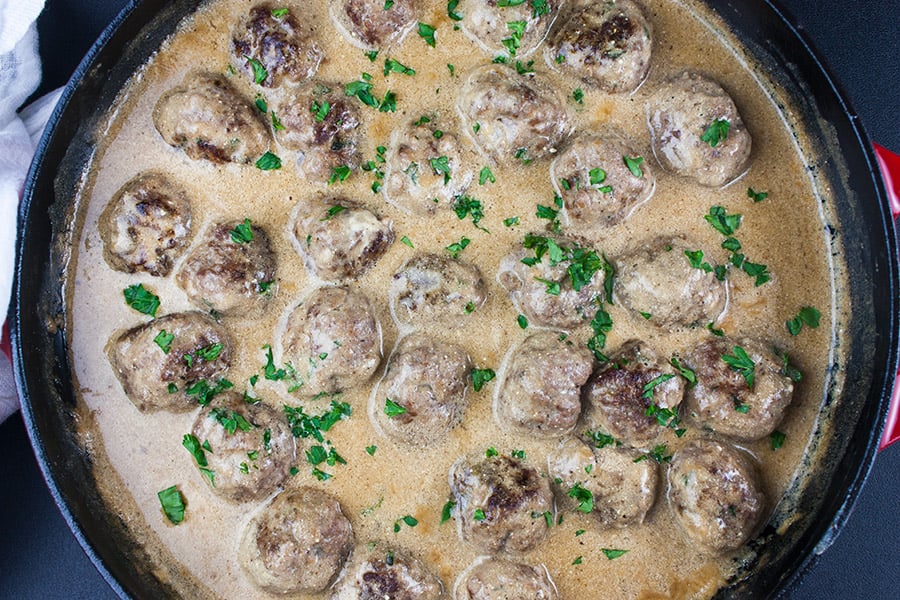 Swedish meatballs in the sauce in a cast iron skillet