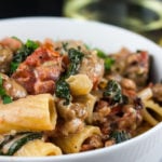 Italian sausage rigatoni in a white bowl.