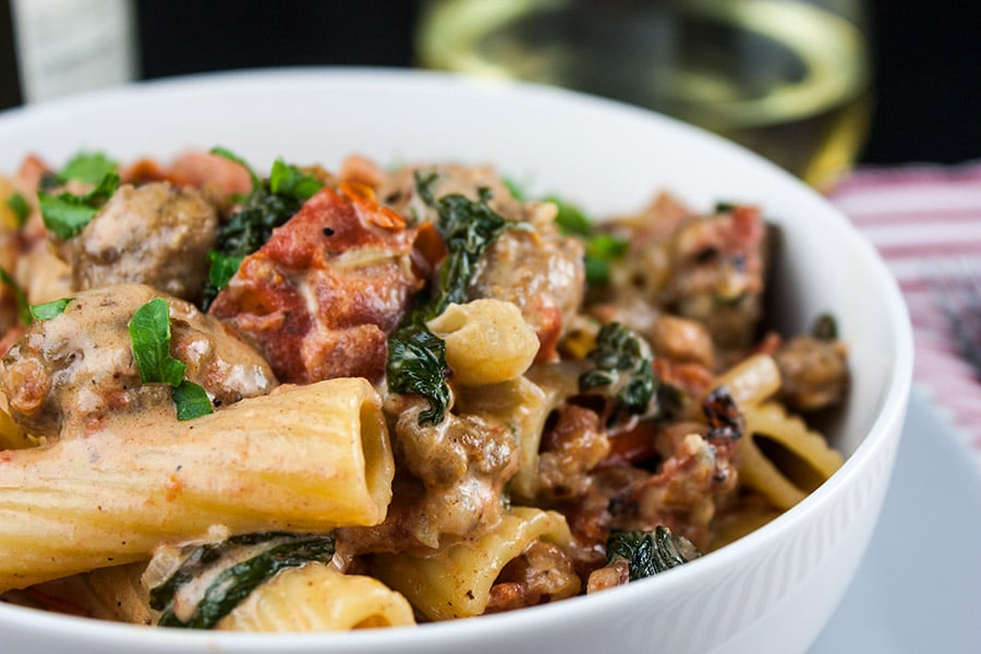 Italian sausage rigatoni in a white bowl.