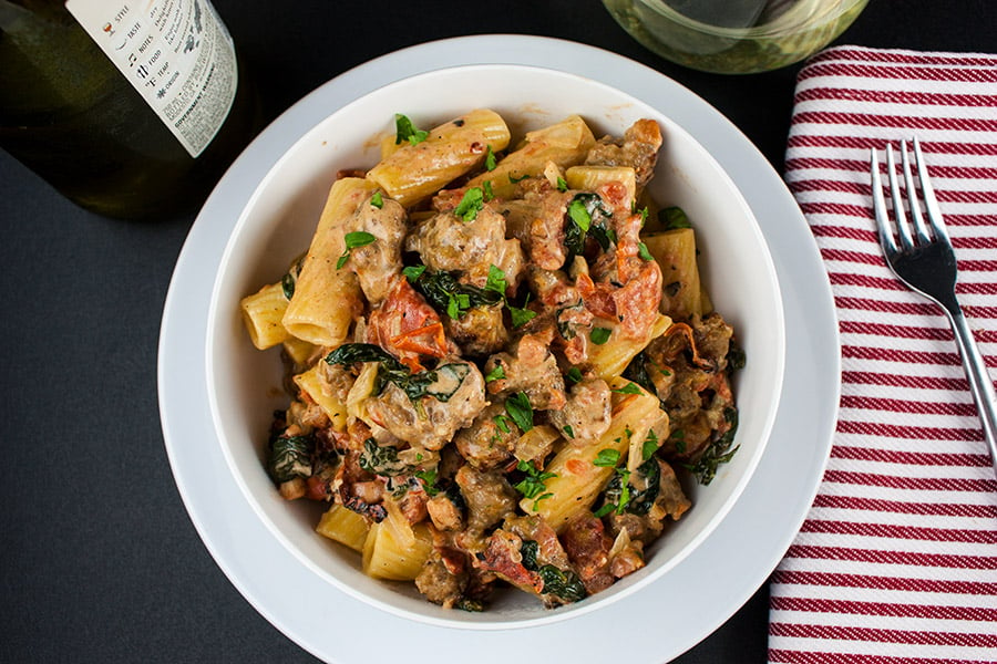 Italian Sausage Rigatoni with Spicy Tomato Cream Sauce - in a white bowl 