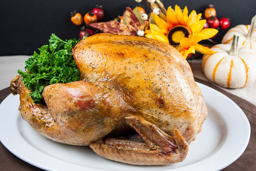 Simple Succulent Roast Turkey (Dry Brine) - cooked turkey on a white platter