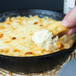 Baked Vidalia Onion Dip in a black serving bowl.