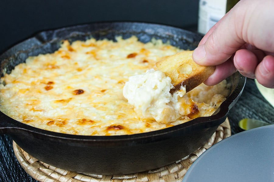 Baked Vidalia Onion Dip in a black serving bowl.