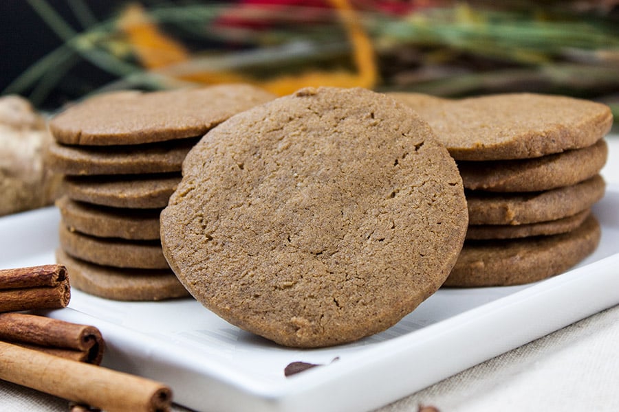 Gingersnap cookies stacked on a white plate.