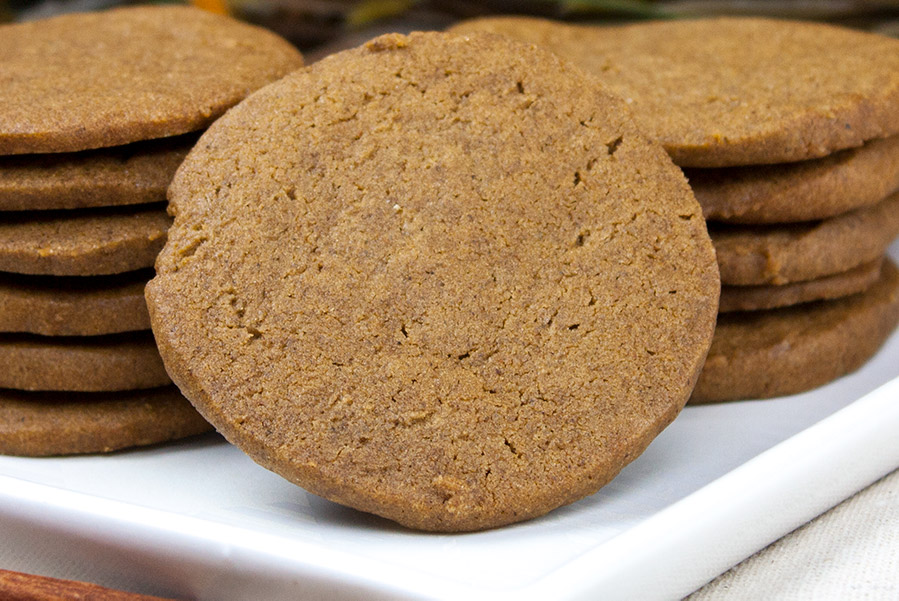 Crispy Gingersnap Cookies - closeup of the cookies stacked on a white plate