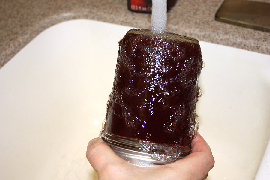 Mason jar upside down under running water.