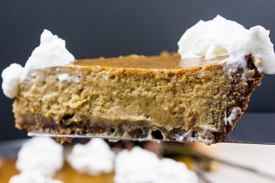 Pumpkin pie with a gingersnap crust being served.