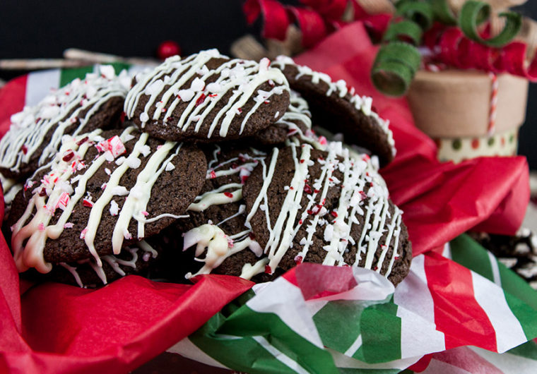 Chocolate Peppermint Cookies stacked in tin with red, white and green tissue paper