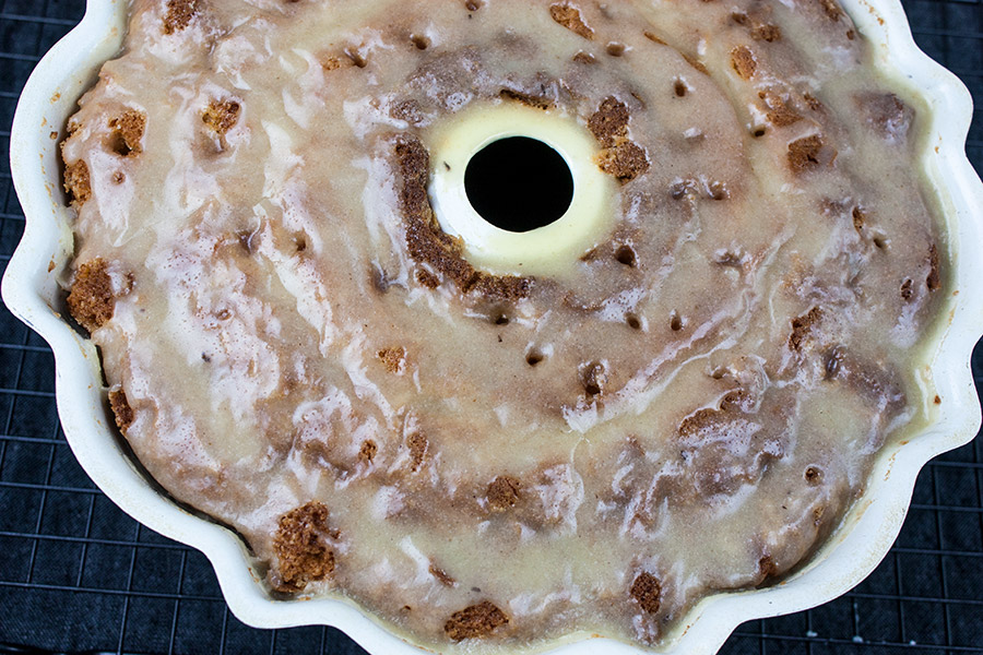 Eggnog Bundt cake in the pan drizzled with the glaze