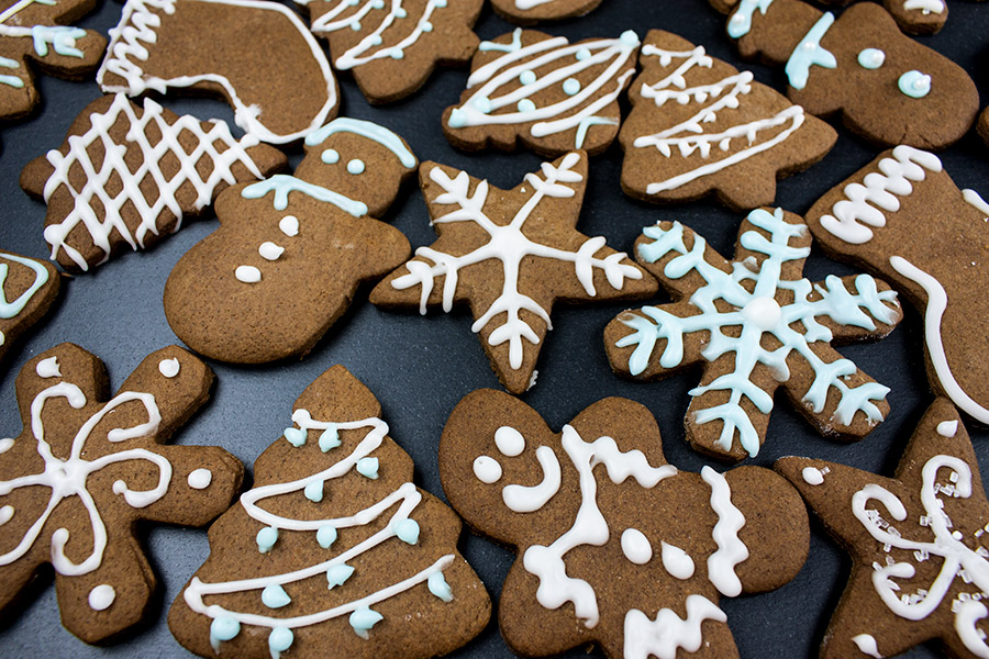 Decorated gingerbread cookies on a slate.